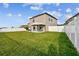 A spacious backyard with a well-maintained lawn and a covered patio area at 11127 Hudson Hills Ln, Riverview, FL 33579