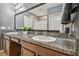 Bathroom showcasing a dual sink vanity with granite countertops and modern fixtures at 11127 Hudson Hills Ln, Riverview, FL 33579
