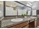 Bathroom showcasing a dual sink vanity with granite countertops and modern fixtures at 11127 Hudson Hills Ln, Riverview, FL 33579