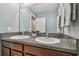 Bathroom vanity featuring double sinks, granite counters, and framed mirror creating a functional space at 11127 Hudson Hills Ln, Riverview, FL 33579