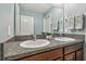 Bathroom featuring a double sink vanity with granite countertops and blue walls at 11127 Hudson Hills Ln, Riverview, FL 33579