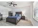 A well-lit bedroom featuring wood-look flooring and a ceiling fan at 11127 Hudson Hills Ln, Riverview, FL 33579