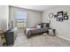 Comfortable bedroom with window, providing a serene space for rest and decorated with creative artwork at 11127 Hudson Hills Ln, Riverview, FL 33579