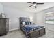A well-lit bedroom featuring wood-look flooring and a ceiling fan at 11127 Hudson Hills Ln, Riverview, FL 33579