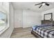 A well-lit bedroom featuring wood-look flooring and a ceiling fan at 11127 Hudson Hills Ln, Riverview, FL 33579