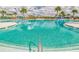Expansive community pool featuring pristine turquoise water, poolside seating and palm trees for a resort-like atmosphere at 11127 Hudson Hills Ln, Riverview, FL 33579