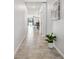 Hallway with tile flooring and a view into the living and dining area at 11127 Hudson Hills Ln, Riverview, FL 33579