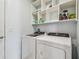 Laundry room featuring washer, dryer, and built-in shelving at 11127 Hudson Hills Ln, Riverview, FL 33579