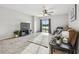 Bright living room with tile floors, neutral colors, and a sliding glass door to the backyard at 11127 Hudson Hills Ln, Riverview, FL 33579
