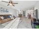 Open-concept living room with tile floors, neutral colors, and seamless flow to the dining and kitchen areas at 11127 Hudson Hills Ln, Riverview, FL 33579