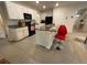 Modern kitchen with white cabinets, black appliances, and breakfast bar at 16949 Secret Meadow Dr, Odessa, FL 33556