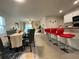 Open-concept living room and dining area features modern decor and a breakfast bar at 16949 Secret Meadow Dr, Odessa, FL 33556