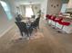 Open concept living area featuring a dining table, breakfast bar, and comfortable seating at 16949 Secret Meadow Dr, Odessa, FL 33556
