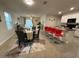 Open-concept living room and dining area features modern decor and a breakfast bar at 16949 Secret Meadow Dr, Odessa, FL 33556