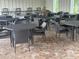 A covered outdoor patio area features ample seating with tables and chairs at 16949 Secret Meadow Dr, Odessa, FL 33556