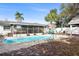 Fenced-in pool with outdoor seating areas and lush greenery at 306 Scott Ct, Palm Harbor, FL 34684