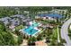 Gorgeous aerial view of pool, tennis courts, lake, clubhouse and parking in a beautiful neighborhood at 4899 Isola Ct, Wesley Chapel, FL 33543
