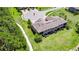 An aerial view showcases the home's backyard, complemented by a walking path and lush trees at 4899 Isola Ct, Wesley Chapel, FL 33543
