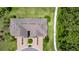Aerial view of a well-maintained home highlighting the roof and surrounding green landscape at 4899 Isola Ct, Wesley Chapel, FL 33543
