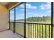 Enjoy the serene pond and lush greenery from this home's screened-in balcony at 4899 Isola Ct, Wesley Chapel, FL 33543