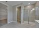Bathroom featuring a glass enclosed shower and access to the walk-in closet at 4899 Isola Ct, Wesley Chapel, FL 33543