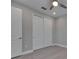Neutral bedroom featuring double-door closet, ceiling fan and light wood flooring at 4899 Isola Ct, Wesley Chapel, FL 33543