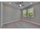 Well-lit bedroom with two windows, ceiling fan and neutral paint throughout at 4899 Isola Ct, Wesley Chapel, FL 33543