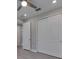 Neutral bedroom with large closet doors and ceiling fan at 4899 Isola Ct, Wesley Chapel, FL 33543