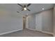 Spacious bedroom featuring wood-look floors, neutral paint, and two doors at 4899 Isola Ct, Wesley Chapel, FL 33543