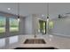 The dining area features bright windows and a modern pendant light at 4899 Isola Ct, Wesley Chapel, FL 33543