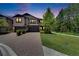 Elegant two-story townhome with a brick driveway and well-manicured landscaping at dusk at 4899 Isola Ct, Wesley Chapel, FL 33543