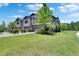 Charming home with tandem garages, inviting entrances, and professionally landscaped yards at 4899 Isola Ct, Wesley Chapel, FL 33543
