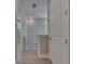 Bright hallway with wood-style flooring, showcasing natural light and neutral paint at 4899 Isola Ct, Wesley Chapel, FL 33543