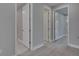 Hallway featuring multiple interior doors and light wood flooring at 4899 Isola Ct, Wesley Chapel, FL 33543