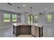 Kitchen island features quartz countertops, stainless steel dishwasher, undermount sink, and pendant lighting at 4899 Isola Ct, Wesley Chapel, FL 33543