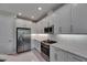 Bright kitchen features stainless steel appliances, a gas range, quartz countertops, and white cabinetry at 4899 Isola Ct, Wesley Chapel, FL 33543