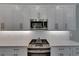 Updated kitchen features quartz countertops, stainless steel appliances, white cabinetry, and gas range at 4899 Isola Ct, Wesley Chapel, FL 33543