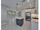 Modern kitchen featuring an island with pendant lighting and stainless steel appliances flowing into living area at 4899 Isola Ct, Wesley Chapel, FL 33543