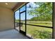 Screened-in lanai with expansive view of pond and green backyard at 4899 Isola Ct, Wesley Chapel, FL 33543