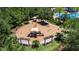 Aerial view of a community playground with slides, swings, and picnic tables surrounded by lush green trees at 4899 Isola Ct, Wesley Chapel, FL 33543
