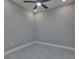 Well-lit room featuring neutral walls, tile floors, and a ceiling fan, great for an office or bedroom at 4899 Isola Ct, Wesley Chapel, FL 33543