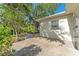 Home's backyard featuring mature trees, landscaping, and room for outdoor entertaining at 8703 Driftwood Dr, Tampa, FL 33615