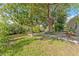 Backyard with large trees and a dock on the water at 8703 Driftwood Dr, Tampa, FL 33615