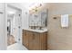 Modern bathroom featuring a stylish vanity with double sinks, elegant fixtures, and a well-lit mirror at 8703 Driftwood Dr, Tampa, FL 33615