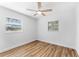 Bright bedroom with wood floors, featuring natural light and neutral finishes at 8703 Driftwood Dr, Tampa, FL 33615
