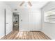 Bright bedroom with wood-look floors, large closet, and modern ceiling fan at 8703 Driftwood Dr, Tampa, FL 33615
