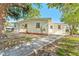 Home exterior with fresh white paint, updated windows and landscaping plus a brick walkway at 8703 Driftwood Dr, Tampa, FL 33615