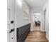 Hallway view to kitchen, dining, and living space with an entry brick accent wall at 8703 Driftwood Dr, Tampa, FL 33615