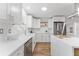 Bright kitchen with stainless steel appliances, white cabinets, subway tile backsplash, and quartz countertop at 8703 Driftwood Dr, Tampa, FL 33615