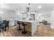 Bright, spacious kitchen featuring white cabinetry, stainless steel appliances, and a stylish island with seating at 8703 Driftwood Dr, Tampa, FL 33615